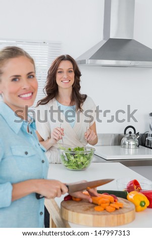 Relaxed women cooking together in the kitchen