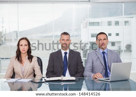 Serious business people waiting for interview in bright office