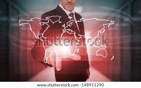 Businessman pressing red world map interface in data center