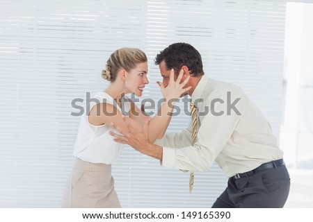Business team having heated argument in bright office