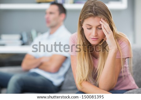 Couple Not Talking After A Dispute On The Sofa In Living Room At Home