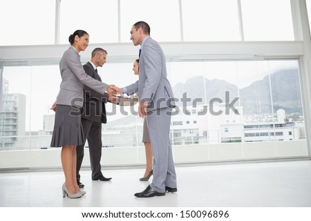 Business People Meeting In Bright Office Shaking Hands