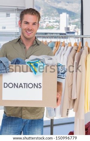 Handsome volunteer holding donation box
