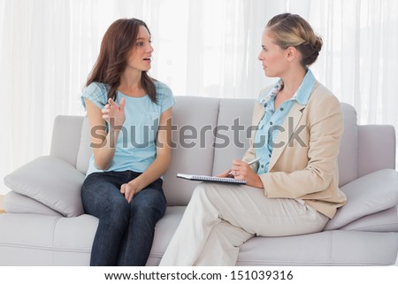 Woman Talking To Her Psychologist And Sitting On The Couch