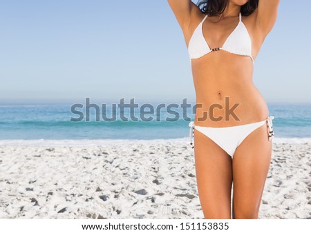 Perfect slim body of attractive young woman on the beach