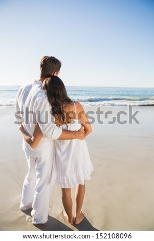 Content couple looking at the waves at the beach