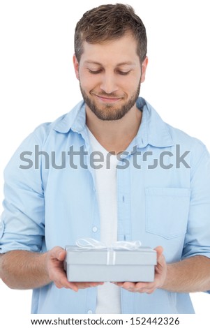 Handsome man holding a present on white background