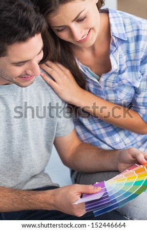 Couple looking at color samples to decorate their new house