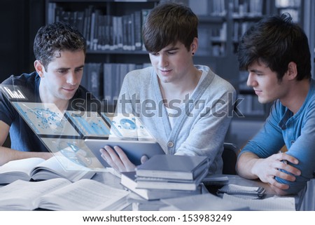 Serious students working on their digital tablet pc in university library