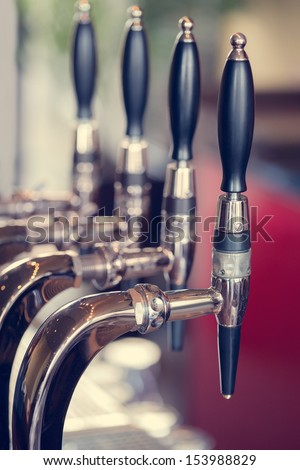 Silver And Black Beer Taps Close Up In A Pub