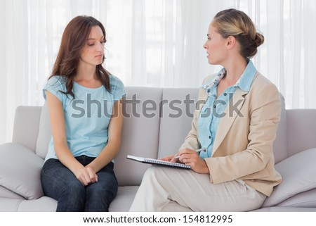 Woman Listening To Her Psychologist And Sitting On The Couch