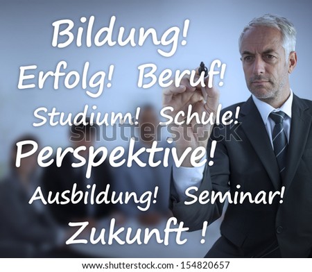 Businessman writing learning terms in german in front of business team