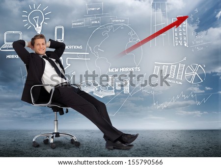 Confident Businessman Reclining In Swivel Chair In Front Of Marketing Flowchart In Desert Landscape