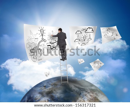 Businessman on a ladder over a planet drawing on a paper with blue sky on the background
