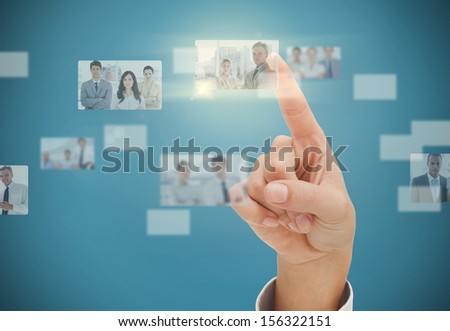 Woman's finger selecting digital interface showing business people