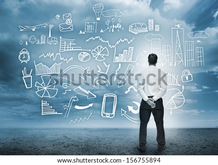 Businessman standing looking at detailed business flowchart in cloudy storm setting
