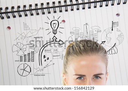 Composite image of angry businesswoman looking at camera in front of economic illustrations drawn on notepad