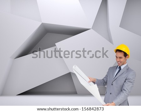 Composite image of smiling architect with hard hat looking at plans standing in abstract room