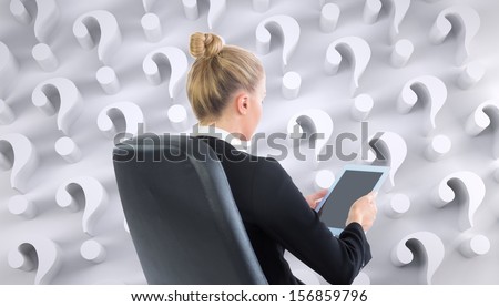 Composite image of businesswoman sitting on swivel chair with tablet on white background covered with question marks
