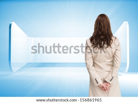 Composite image of rear view of businesswoman crossing hands behind back standing in abstract blue room