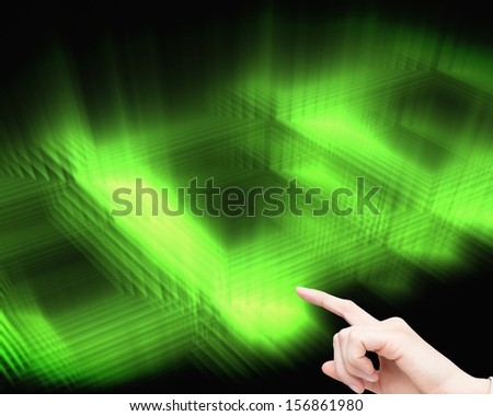 Composite image of businesswoman touching invisible screen on black and green glowing background