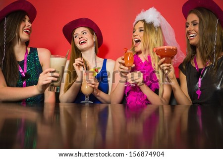Laughing Friends At A Hen Night Drinking Cocktails And Chatting