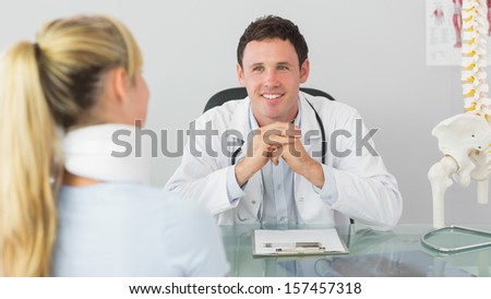 Smiling doctor having an appointment with a patient in bright office