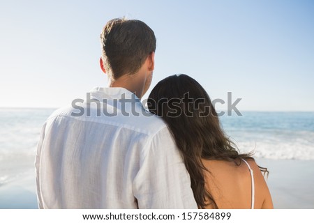 Peaceful couple looking at the ocean at the beach