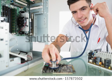 Handsome happy computer engineer holding stethoscope in bright office