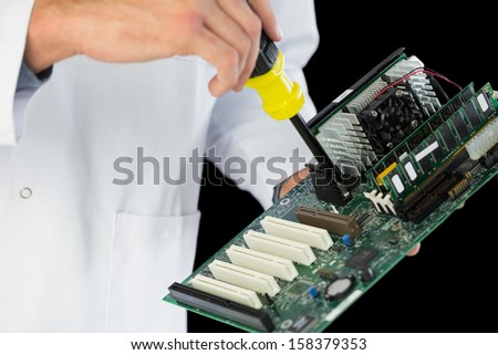 Extreme close up of computer engineer repairing hardware at night on black background