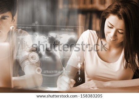 Smiling college student analyzing map on digital interface in university library