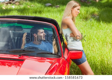 Young couple having a dispute while going on holidays together