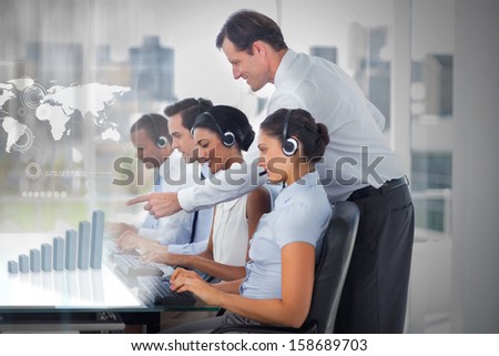Call center employees at work on futuristic interfaces showing map and graph with supervisor in the office