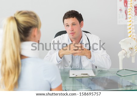 Concerned doctor having an appointment with a patient in bright office