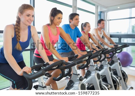 Determined five people working out at class in gym