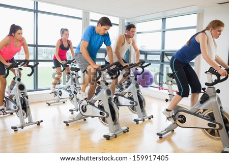 Determined five people working out in gym
