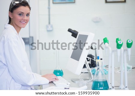 Side view portrait of a young female researcher using computer in the laboratory