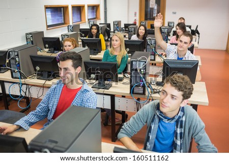 Group of concentrated students using computers in the college computer room