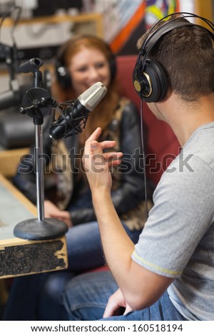 Attractive Smiling Radio Host Interviewing A Guest In Studio At College