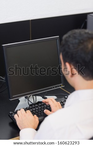 Close-up rear view of a mature student using computer in the computer room