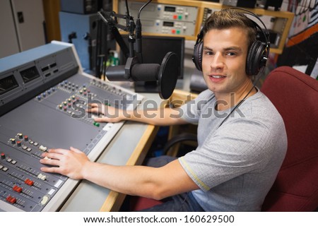 Handsome Smiling Radio Host Moderating In Studio At College