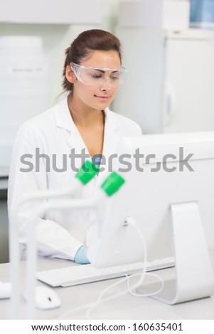 Young female researcher using a computer in the laboratory