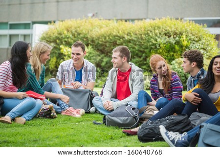Group of young college students sitting in the park