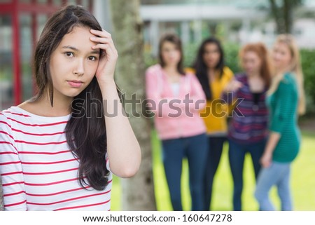 Portrait Of A Female Student Being Bullied By Other Group Of Students