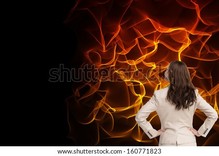 Composite image of businesswoman standing back to camera with hands on hips on white background