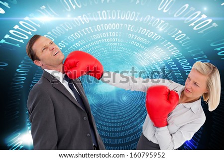 Composite image of businesswoman hitting colleague with her boxing gloves on white background