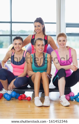 Portrait of a group of fitness class at a bright exercise room