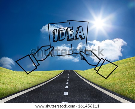 Graphic with two hands holding an idea on bright countryside