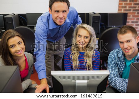 Portrait of a teacher with college students in the computer room