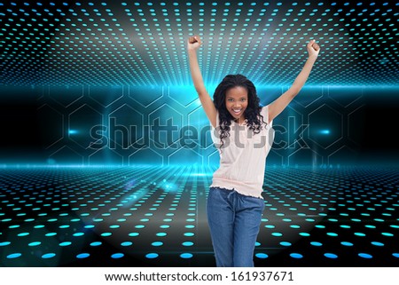Composite image of a happy young woman is standing with her hands in the air
